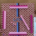 Overhead view of the L'Été Indien Voyage mahjong mat with a handpainted monogram