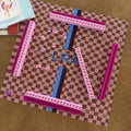 L'Été Indien Voyage travel mahjong mat styled on a table with a matching La Pochette pouch